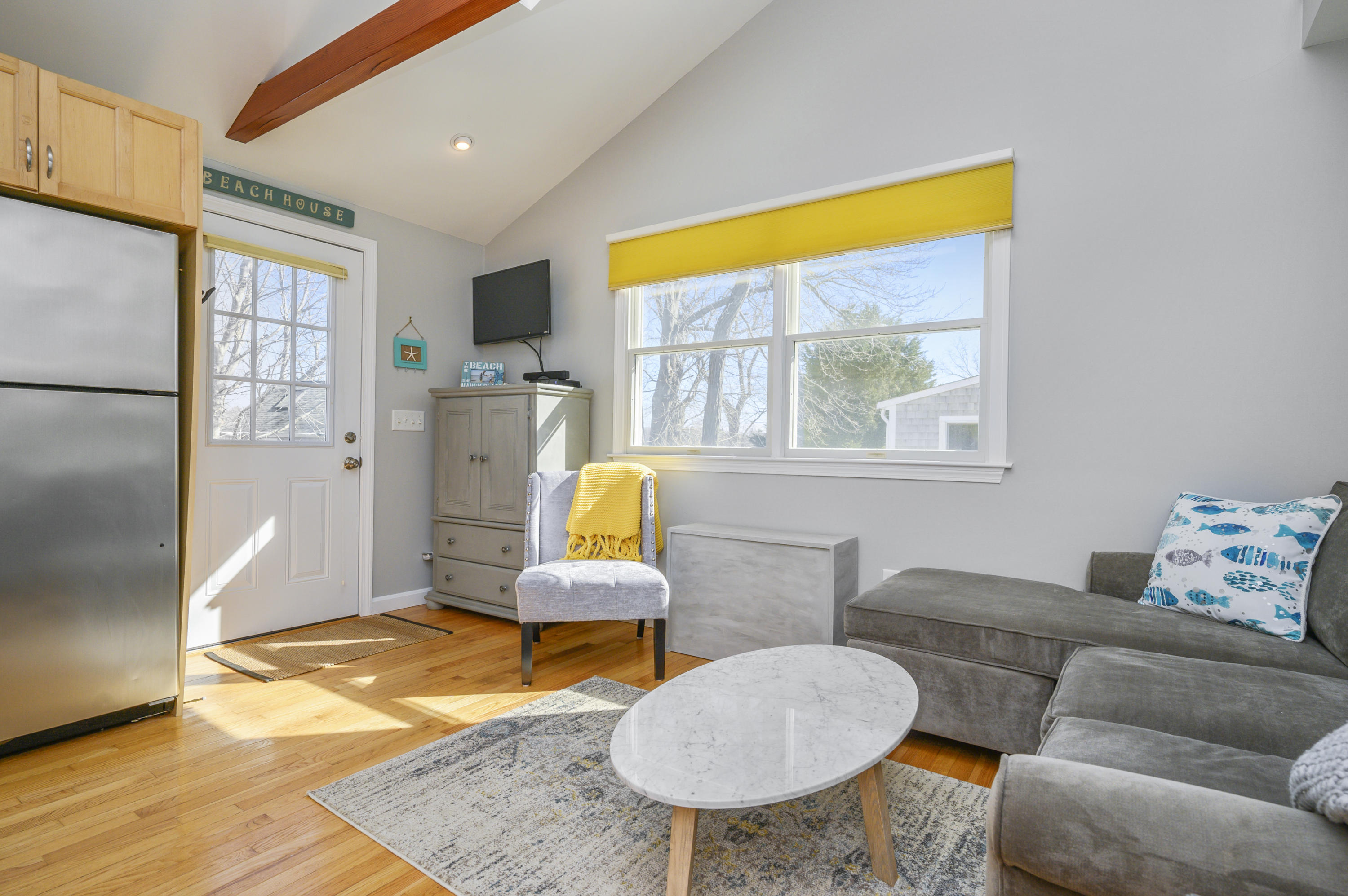 27 Locust Road, Unit 2 Eastham, MA 02642 - Photo 5 of 26 a living room with furniture a rug and a window