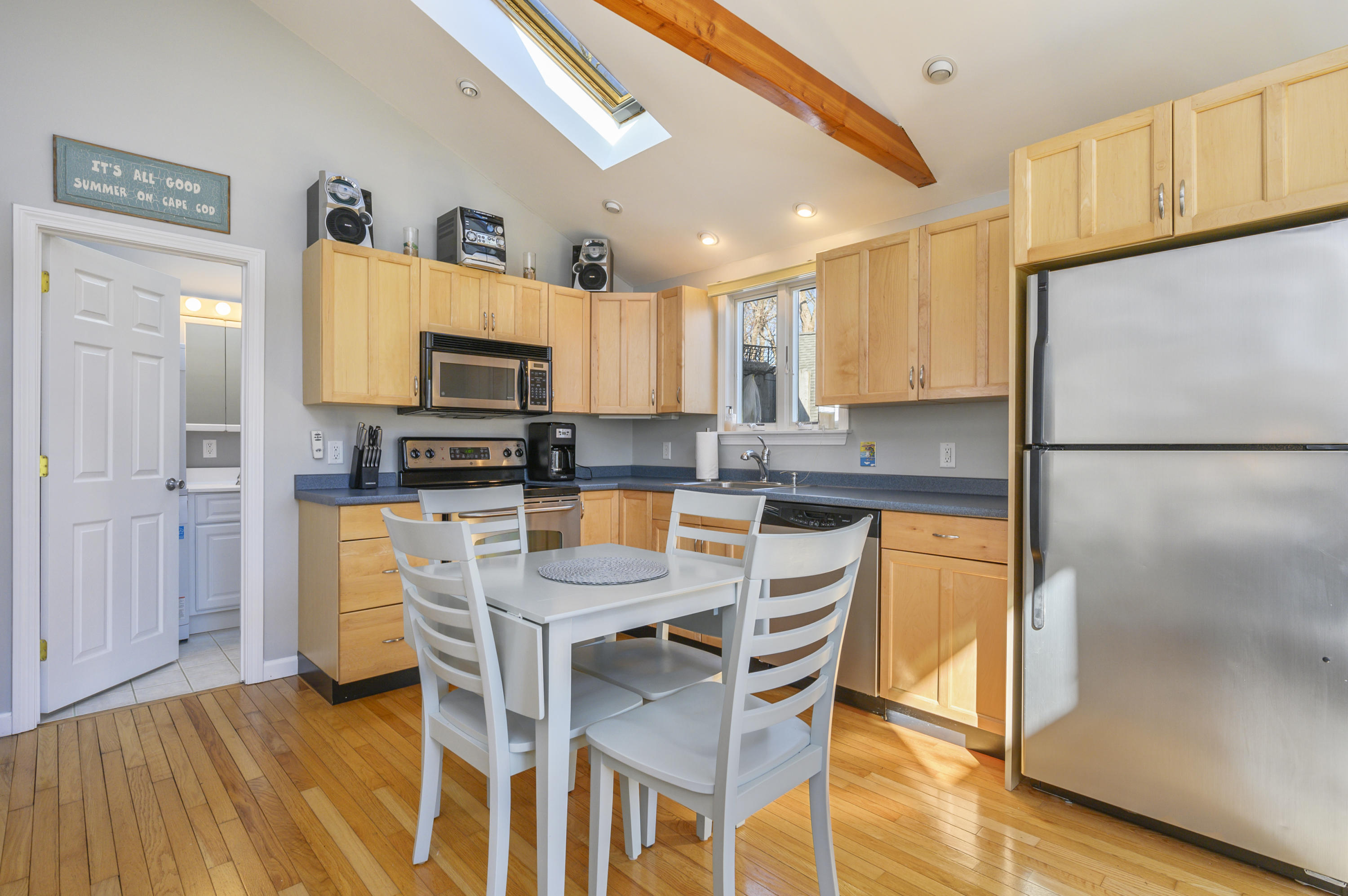 27 Locust Road, Unit 2 Eastham, MA 02642 - Photo 6 of 26 a kitchen with stainless steel appliances granite countertop a refrigerator a stove top oven and a sink