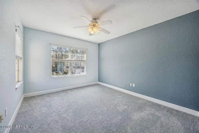 a bathroom with a granite countertop sink a mirror and a shower
