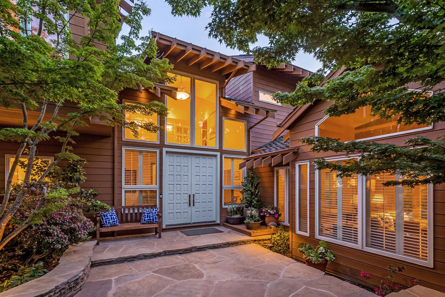 a view of a house with a patio and a yard