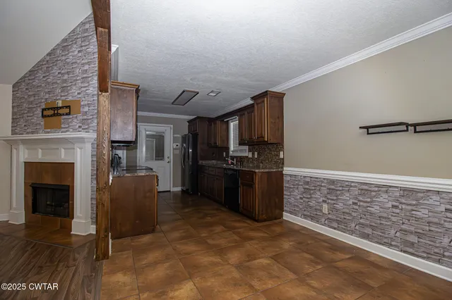 a view of kitchen with furniture and a fireplace