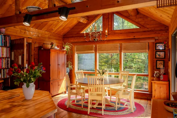 a view of a patio with a table and chairs potted plants