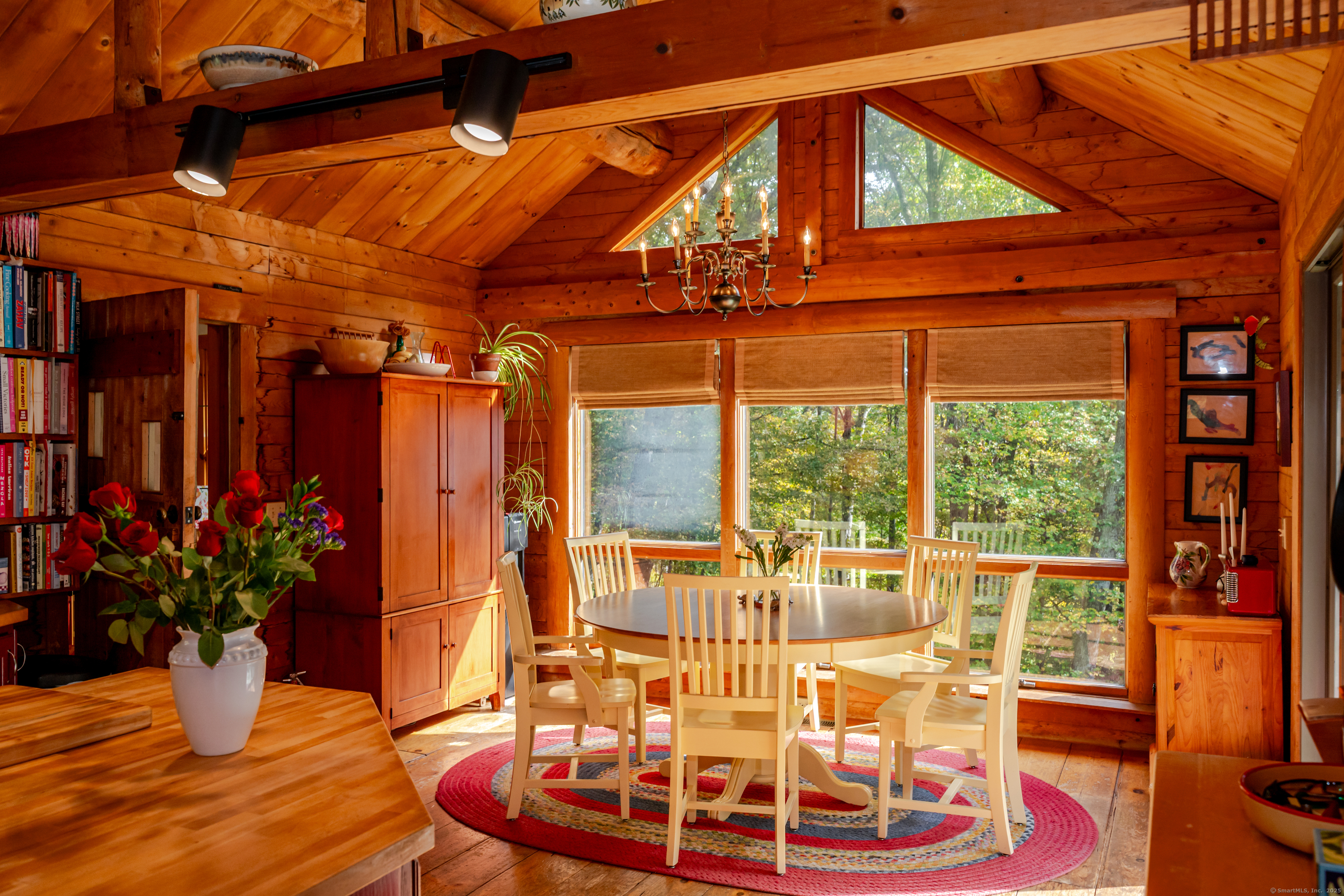 a view of a patio with a table and chairs potted plants