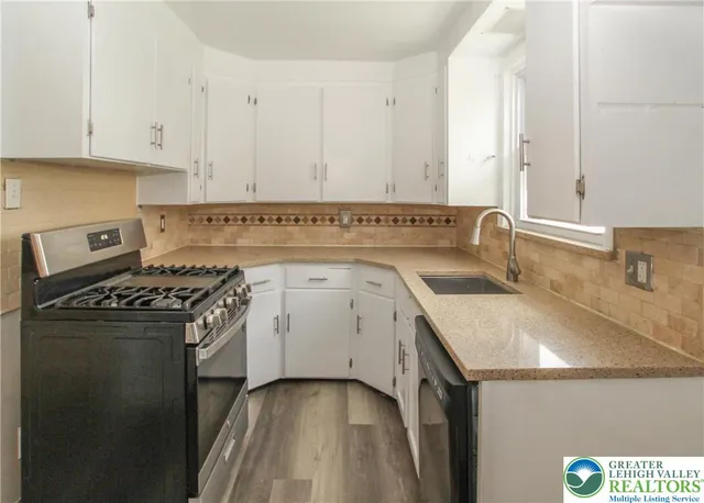 a kitchen with a sink stove and cabinets
