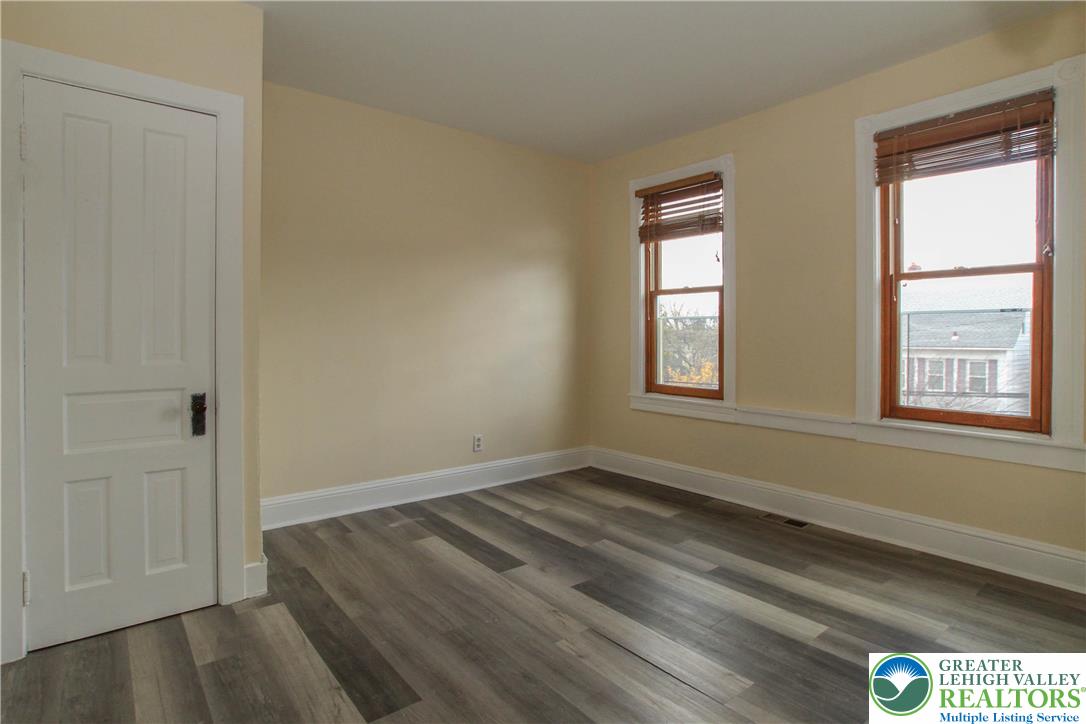 1522 Center Street, Unit 1 Bethlehem, PA 18018 - Photo 16 of 19 a view of an empty room with wooden floor and a window