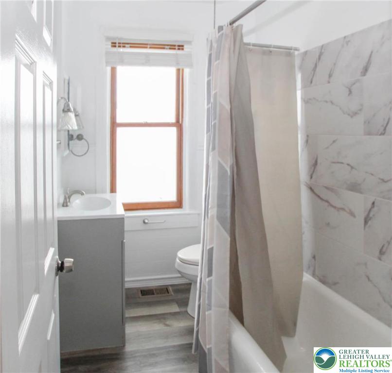1522 Center Street, Unit 1 Bethlehem, PA 18018 - Photo 17 of 19 a bathroom with a bathtub a sink and a window
