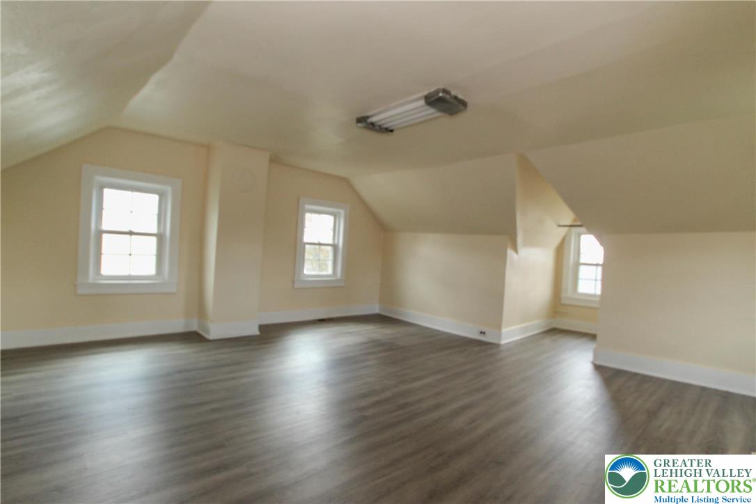 1522 Center Street, Unit 1 Bethlehem, PA 18018 - Photo 18 of 19 an empty room with wooden floor and windows