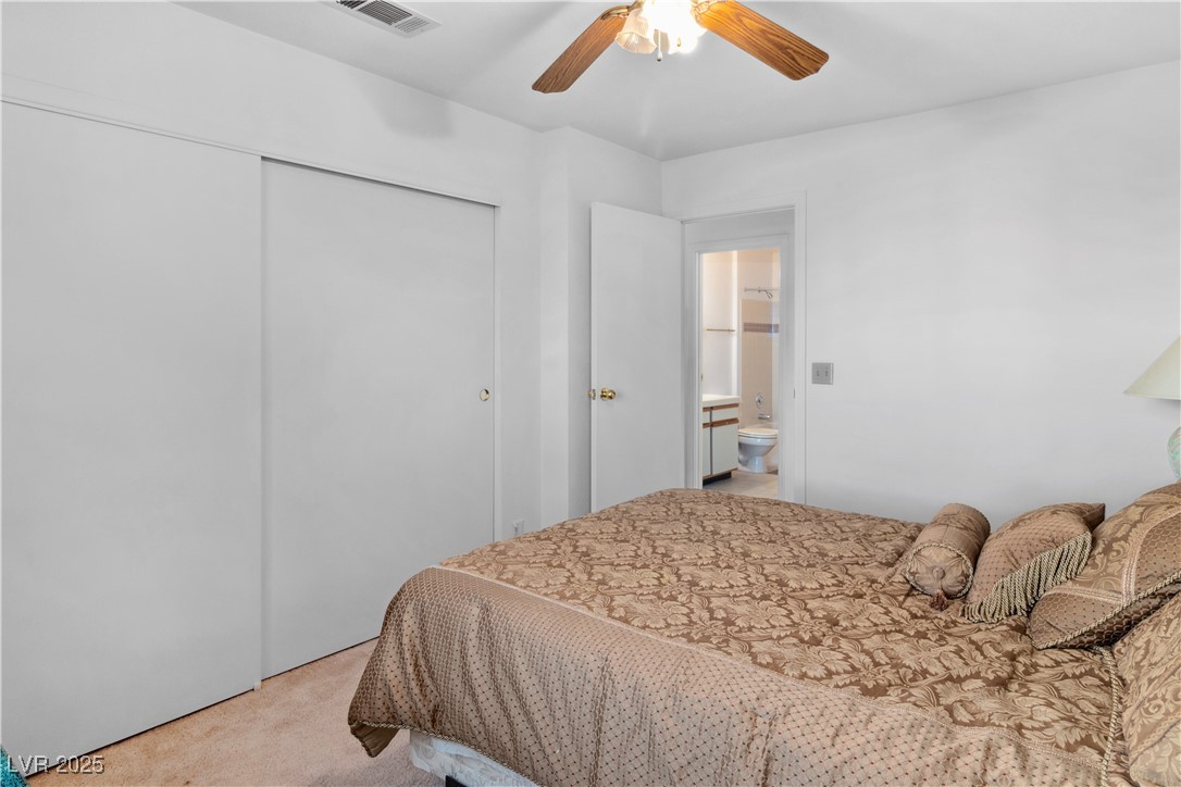 1928 Las Palmas Lane, Unit 228 Laughlin, NV 89029 - Photo 20 of 77 Secondary Bedroom with light colored carpet, a closet, and a ceiling fan