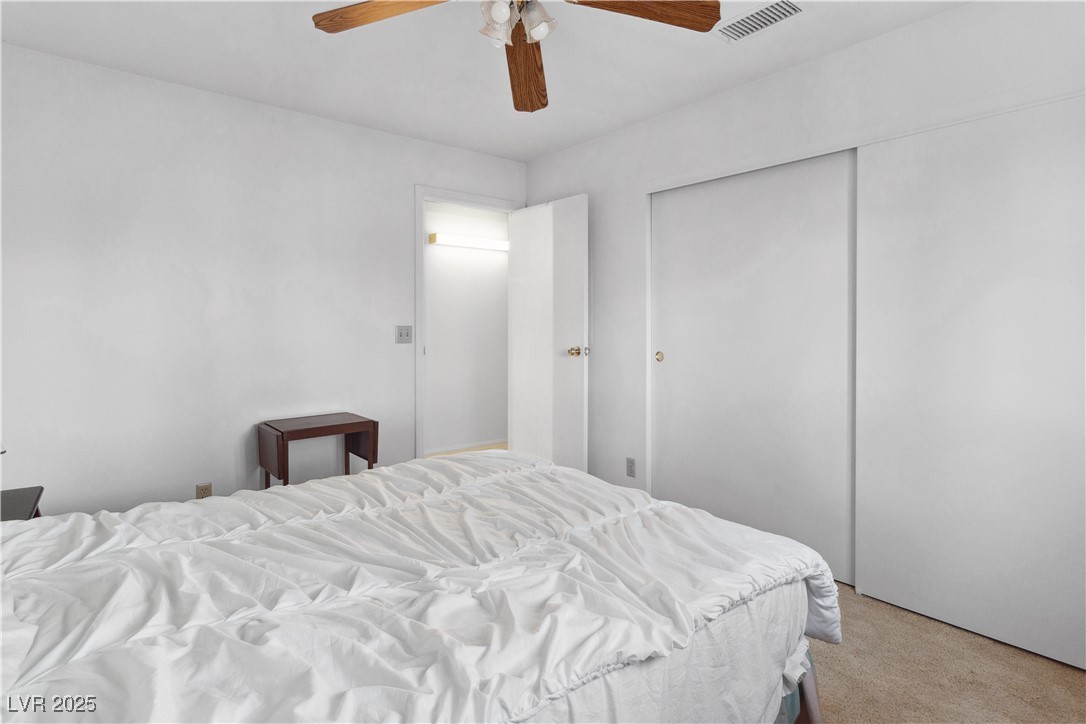 1928 Las Palmas Lane, Unit 228 Laughlin, NV 89029 - Photo 25 of 77 Third Bedroom with light carpet, ceiling fan, and a closet