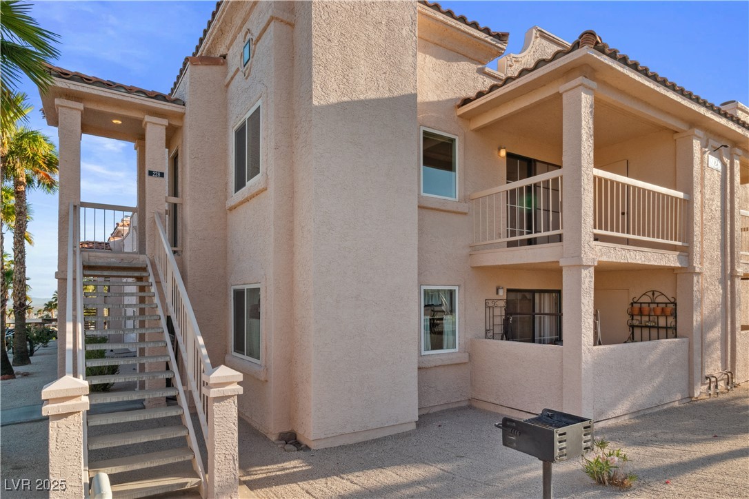1928 Las Palmas Lane, Unit 228 Laughlin, NV 89029 - Photo 3 of 77 Front of the property, located on the second floor, with staircase to front door entry, also visible is the covered balcony that overlooks the local park
