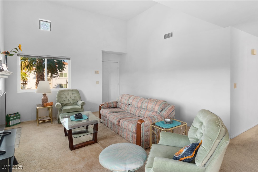 1928 Las Palmas Lane, Unit 228 Laughlin, NV 89029 - Photo 8 of 77 Living area with a high ceiling, carpet floors, and plenty of natural light