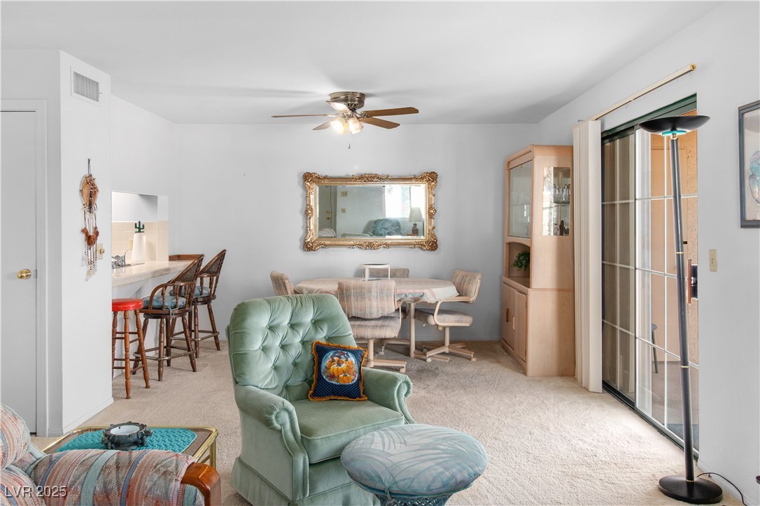 1928 Las Palmas Lane, Unit 228 Laughlin, NV 89029 - Photo 10 of 77 Carpeted living area with a ceiling fan
