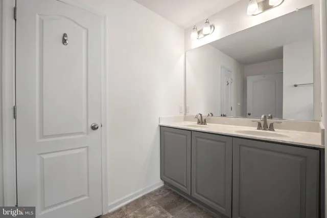 a bathroom with a double vanity sink and mirror