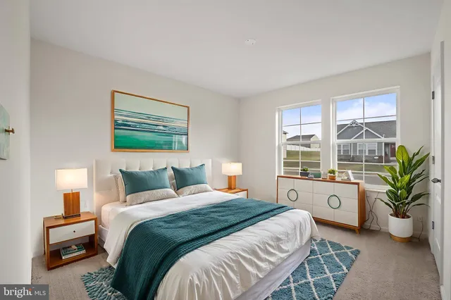 a bedroom with a bed and potted plant