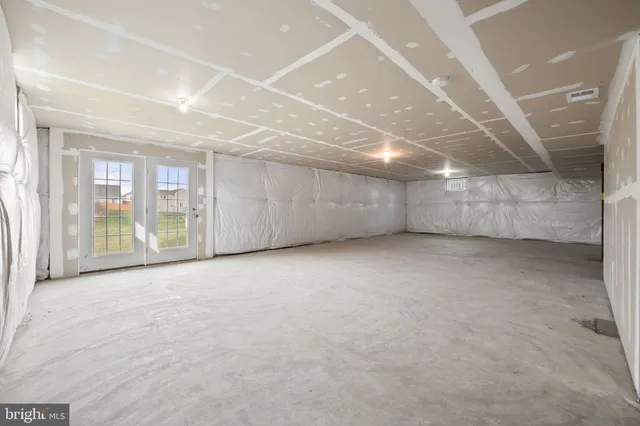 a view of an empty room with glass door
