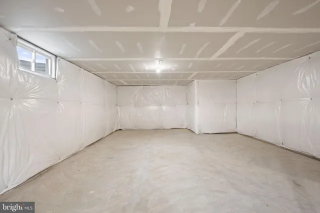 an empty room with a empty space and windows