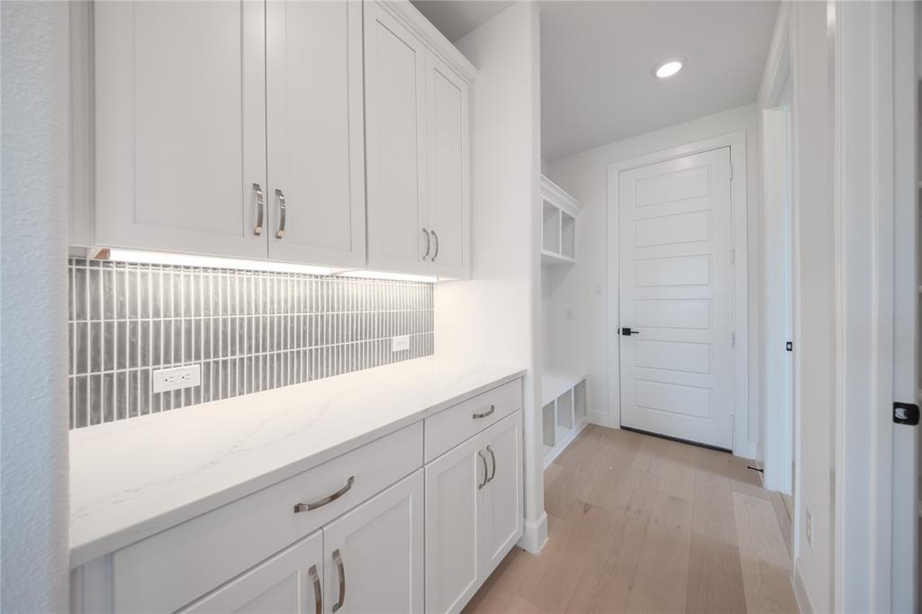 2719 Triumph Court Heath, TX 75126 - Photo 24 of 39 a view of storage and utility room with wooden floor