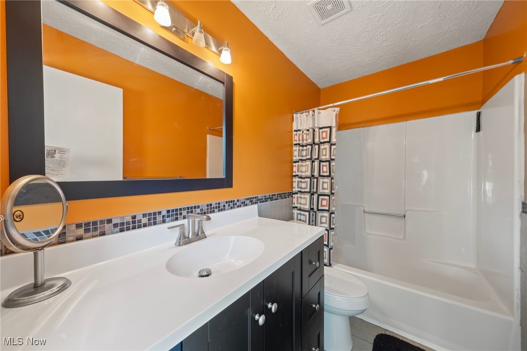 28402 Forest Road Willowick, OH 44095 - Photo 12 of 18 Full bathroom featuring tile patterned floors, toilet, shower / tub combo and vanity