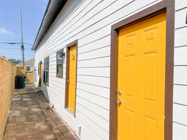a view of a porch with wooden floor and a door