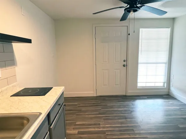 a view of storage and utility room with wooden floor