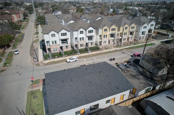 an aerial view of residential houses with outdoor space