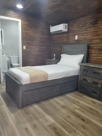 a bedroom with a bed and walk in closet