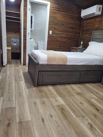 a bedroom with a bed and a cabinets