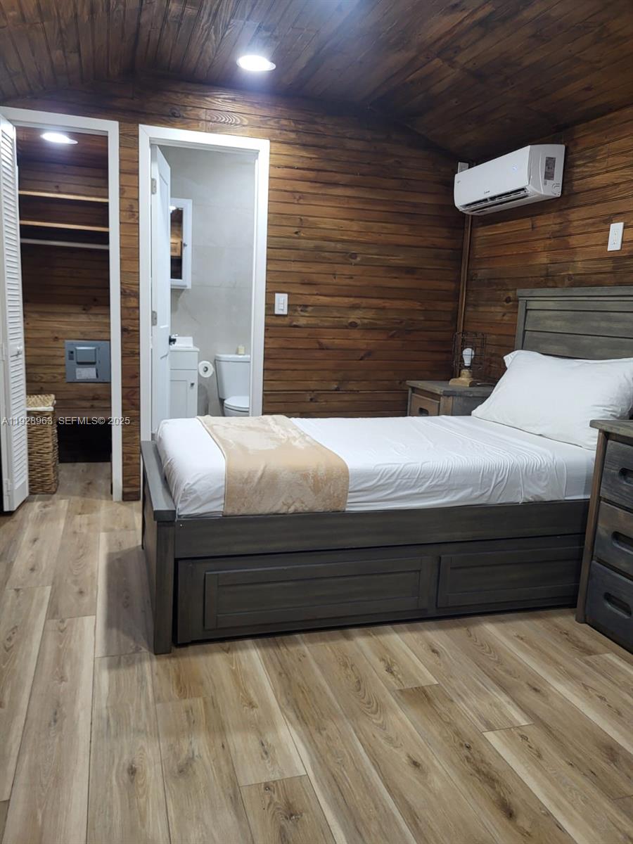 2137 Northwest 97th Street, Unit 2137 Miami, FL 33147 - Photo 13 of 19 a bedroom with a bed and a cabinets