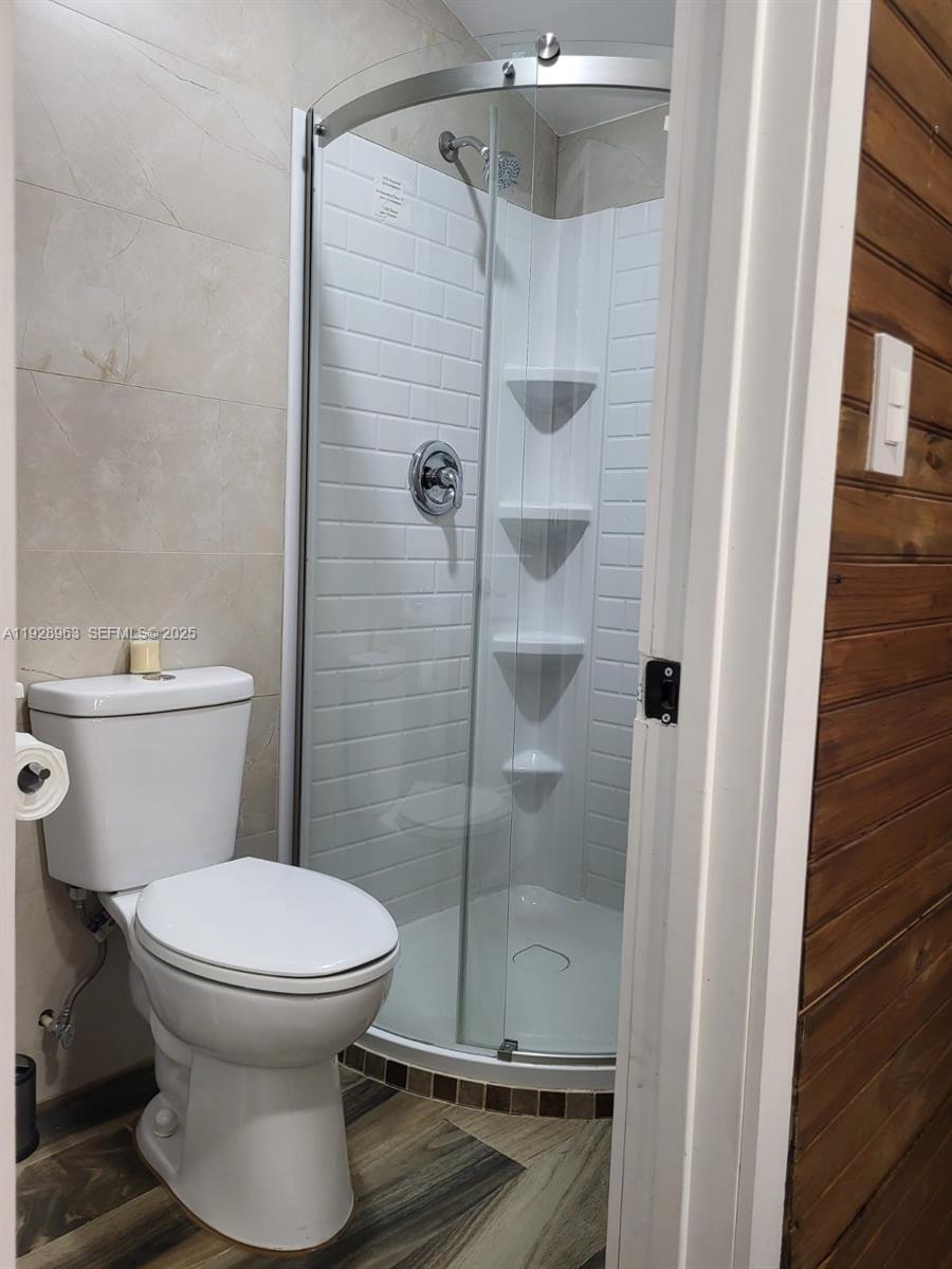 2137 Northwest 97th Street, Unit 2137 Miami, FL 33147 - Photo 16 of 19 a bathroom with a toilet and a shower