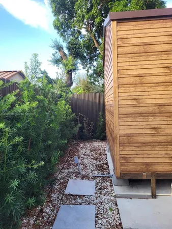 a kitchen with kitchen island granite countertop wooden cabinets and white appliances