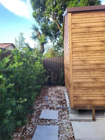 a kitchen with kitchen island granite countertop wooden cabinets and white appliances