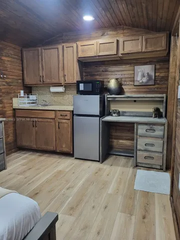 a kitchen with a stove and a refrigerator