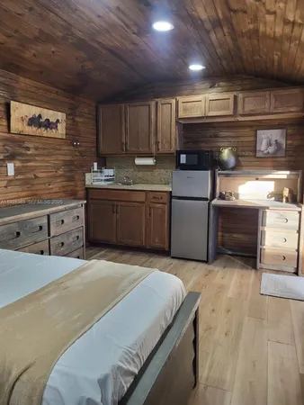 a bedroom with a bed and cabinet