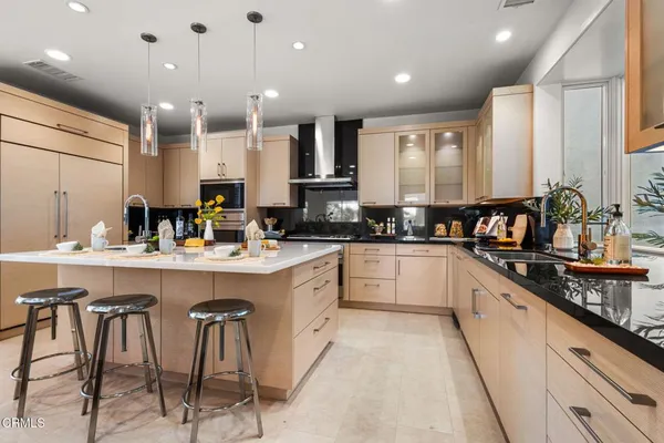 a large kitchen with stainless steel appliances lots of counter space and a sink