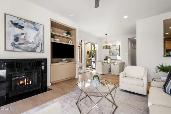 an aerial view of a house with a yard and trees all around