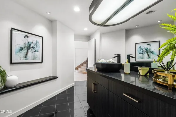 a view of a house with pool and sitting area