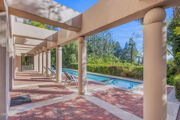 a spacious bedroom with a bed and a potted plant