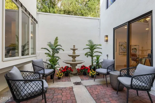 a bedroom with a bed couch and a large window