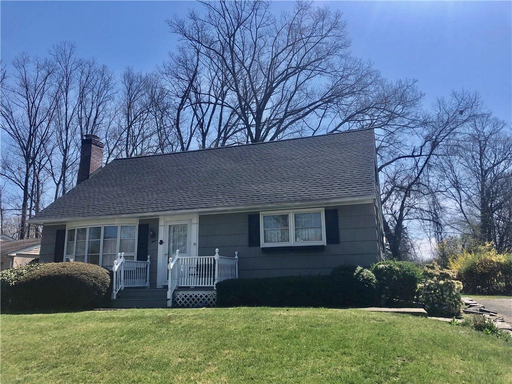 a front view of house with yard and green space