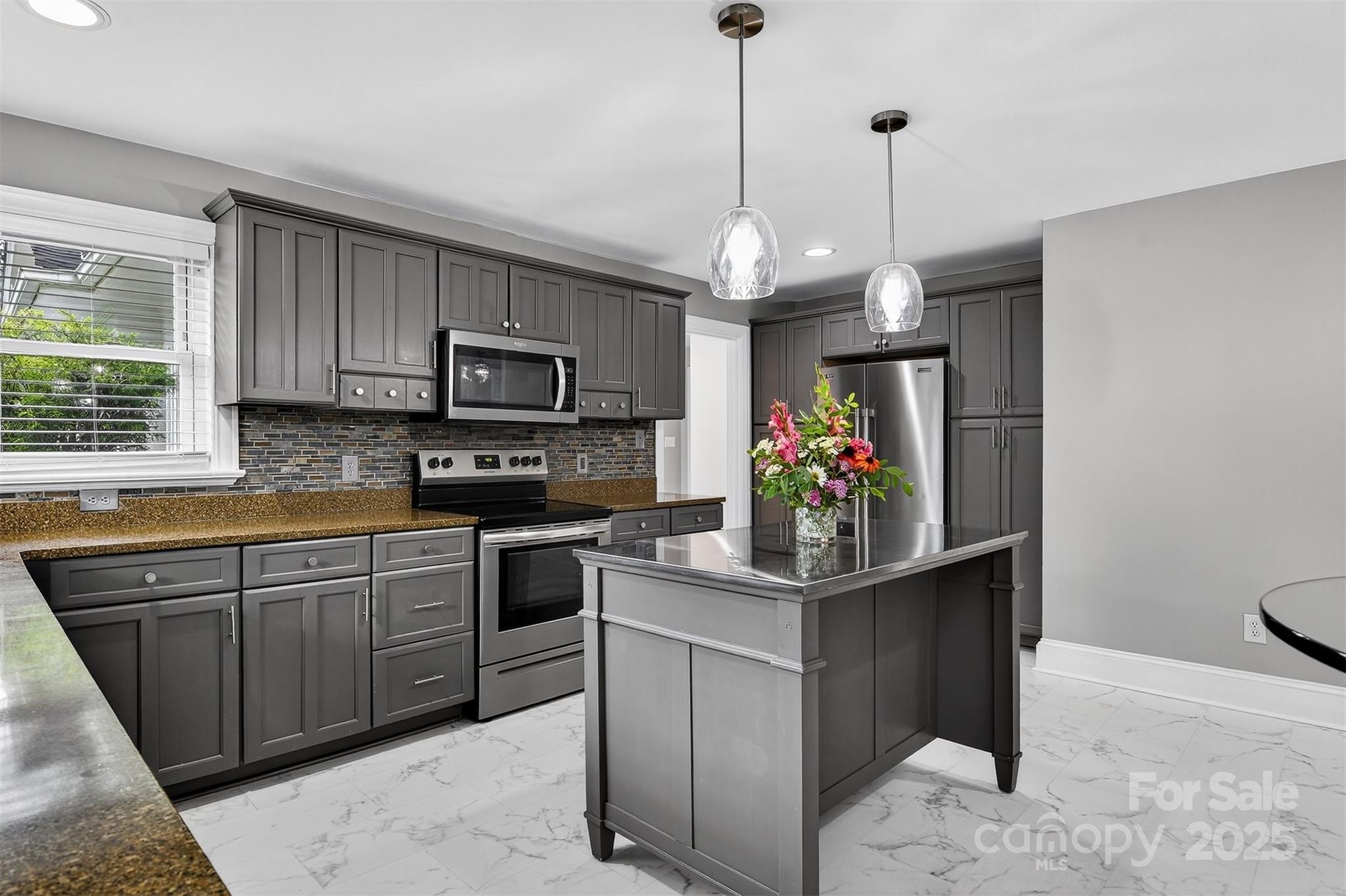 3127 North Center Street Hickory, NC 28601 - Photo 11 of 47 a kitchen with stainless steel appliances granite countertop a stove and a wooden cabinets