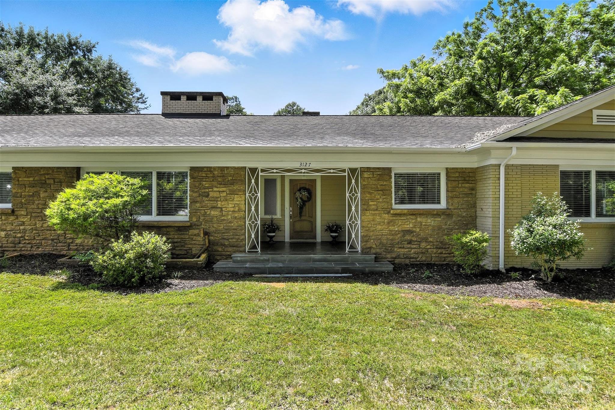 3127 North Center Street Hickory, NC 28601 - Photo 2 of 47 a front view of a house with a yard