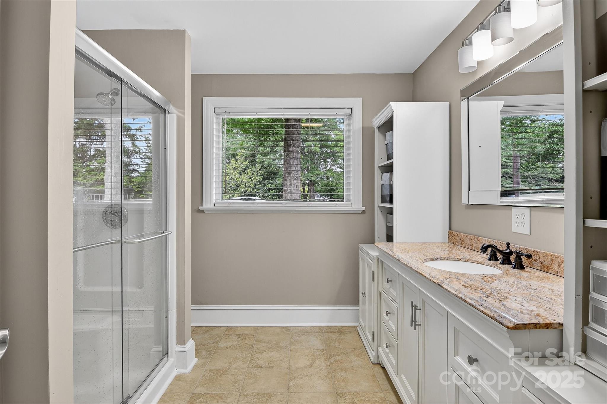 3127 North Center Street Hickory, NC 28601 - Photo 22 of 47 a bathroom with a granite countertop sink and a window