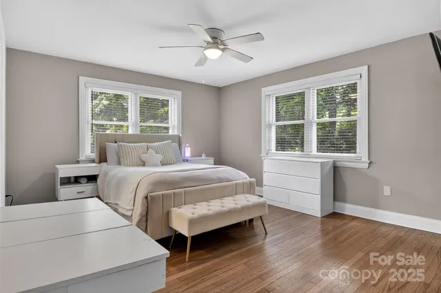 a bedroom with a large bed and a large window