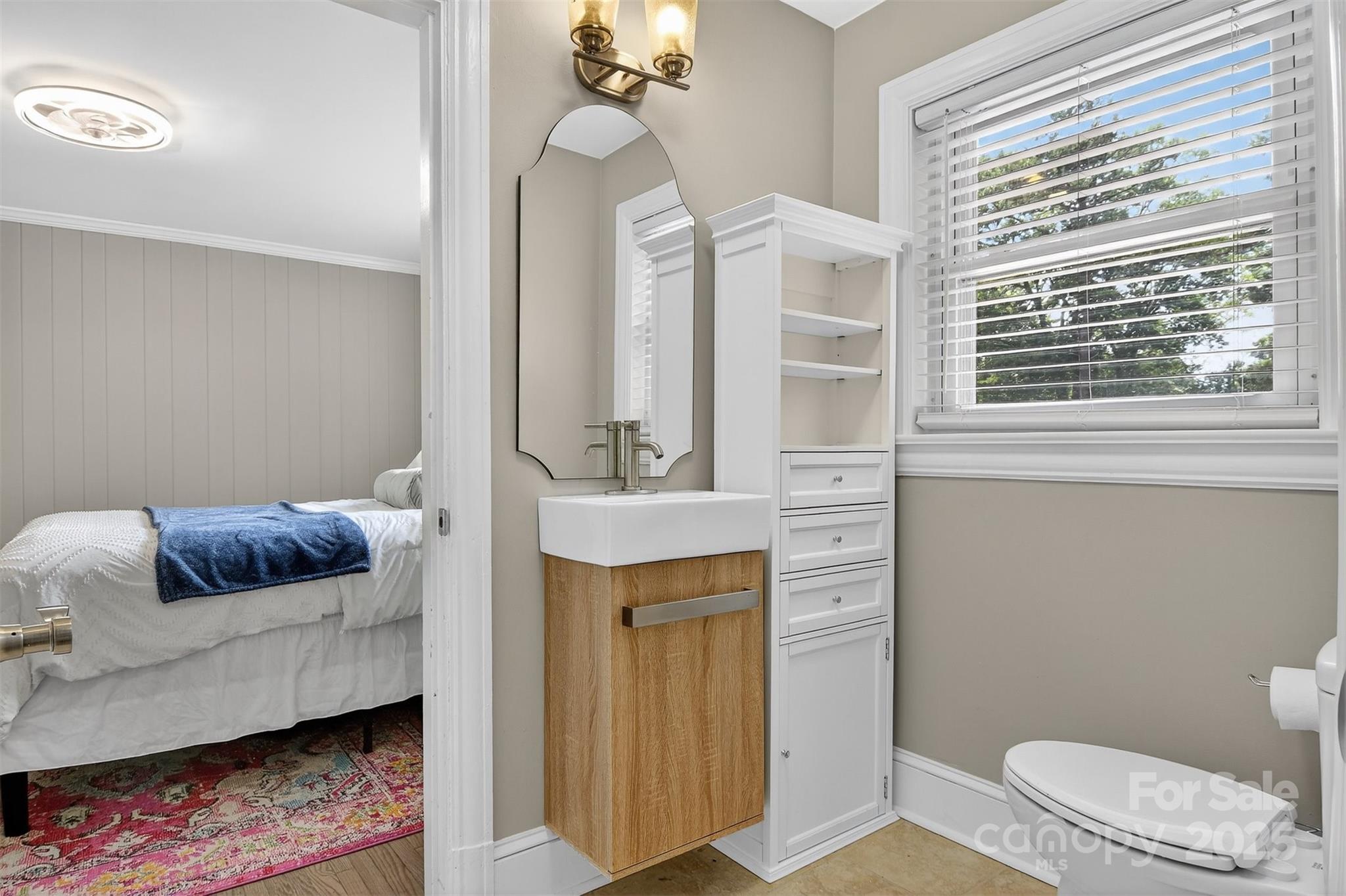3127 North Center Street Hickory, NC 28601 - Photo 26 of 47 a bathroom with a toilet a sink and a mirror