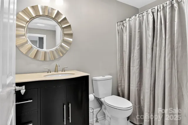 a bathroom with a toilet a sink and a mirror