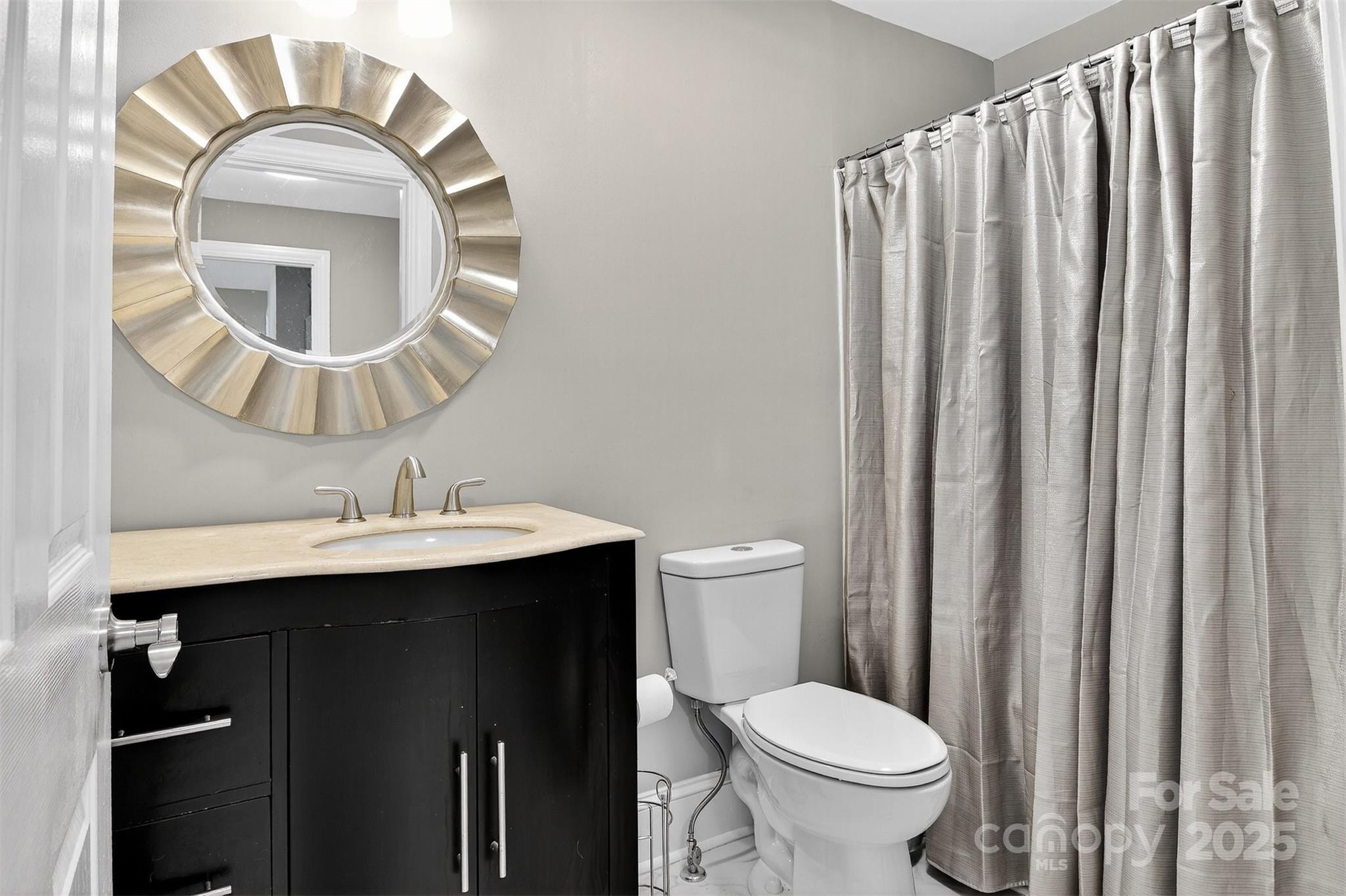 3127 North Center Street Hickory, NC 28601 - Photo 28 of 47 a bathroom with a toilet a sink and a mirror