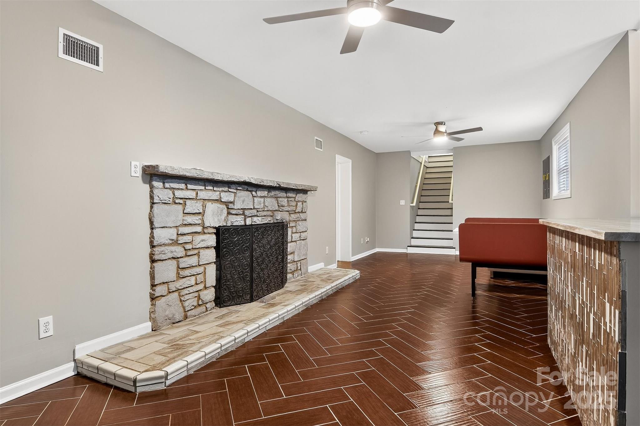 3127 North Center Street Hickory, NC 28601 - Photo 30 of 47 a living room with furniture a fireplace and a chandelier