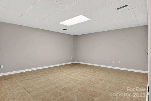 an empty room with a projector and cabinets
