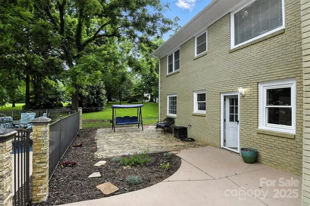 a view of a house with backyard porch and sitting area