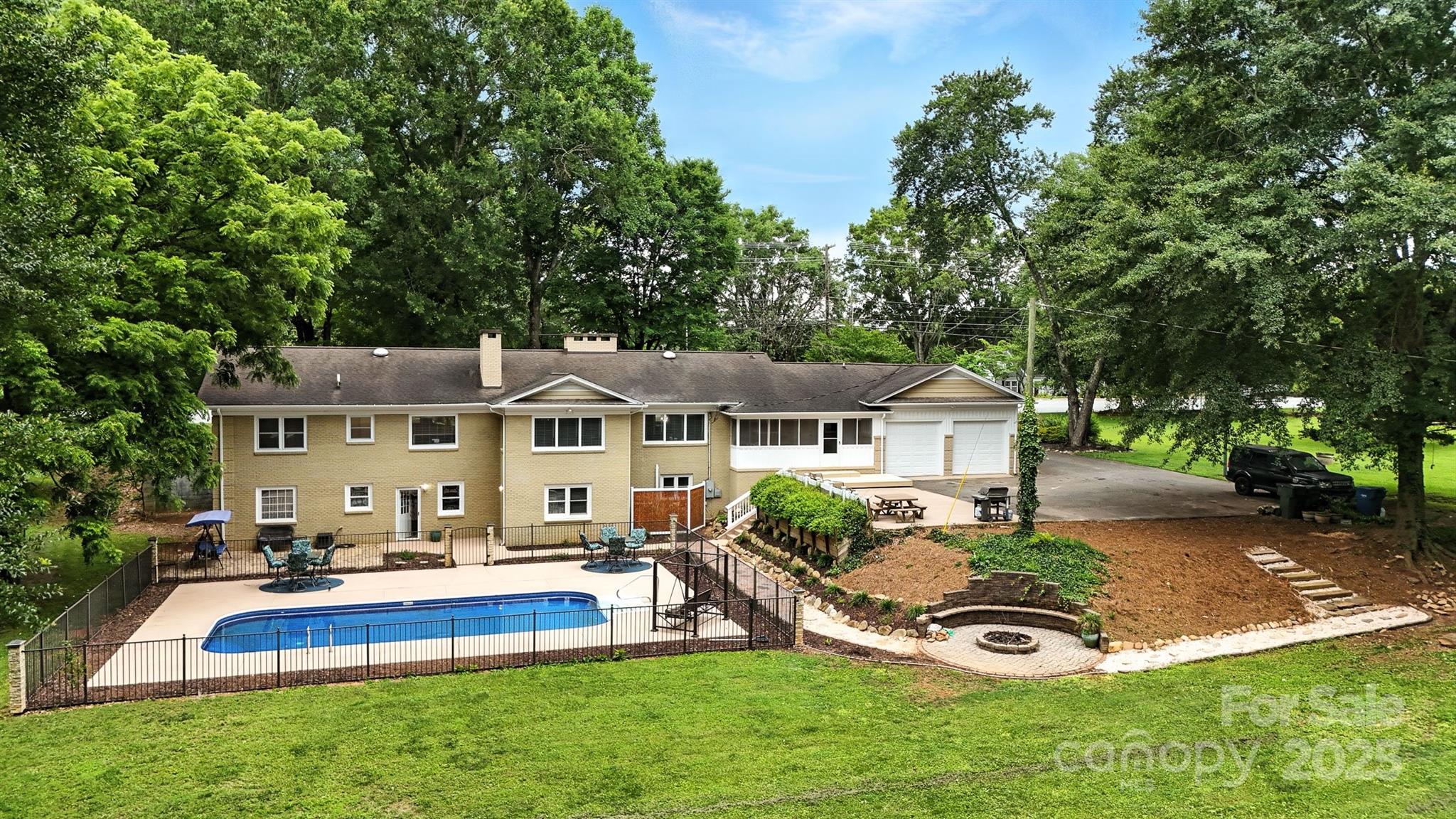 3127 North Center Street Hickory, NC 28601 - Photo 43 of 47 a view of a house with a big yard potted plants and large tree